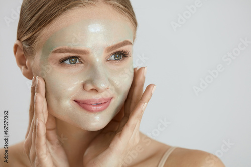 Cosmetic Mask. Beautiful Smiling Woman Applying Mask On Face