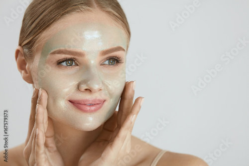Cosmetic Mask. Beautiful  Smiling Woman Applying Mask On Face