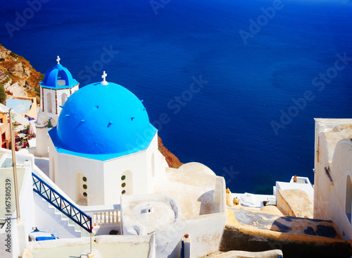 traditional blue dome of church and blue sea water, Oia, Santorini, retro toned