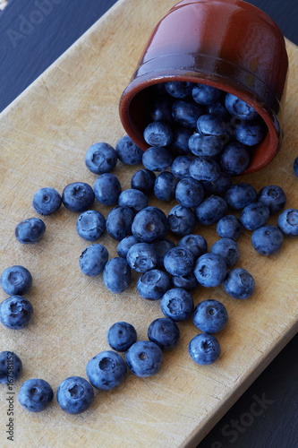 Blueberry on wooden background. Ripe and juicy fresh picked blueberries closeup