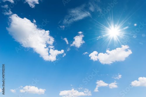 Blue sky background with the sun Blue sky with white clouds floating in the sky.