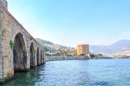 Old shipyard as part of Alanya fortress with red tower background in Alanya, Turkey