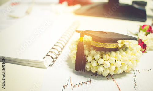 Billede på lærred Concept of congratulate graduate study success, graduation black cap on Jasmine garland