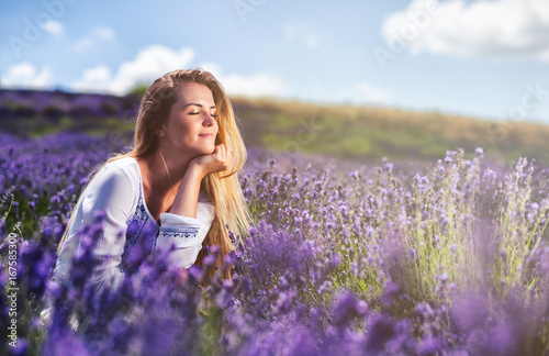 Lovely cute woman in lavender field at sunny day freedom concept