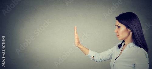 Side profile of woman with stop hand gesture