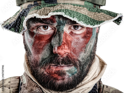 Special forces United States in Camouflage Uniforms studio shot. Wearing jungle hat, Shemagh scarf, painted with red and green face. Studio shot isolated