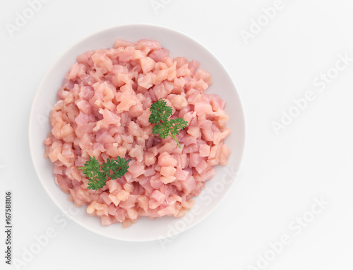 Plate of raw chicken cuts on white background
