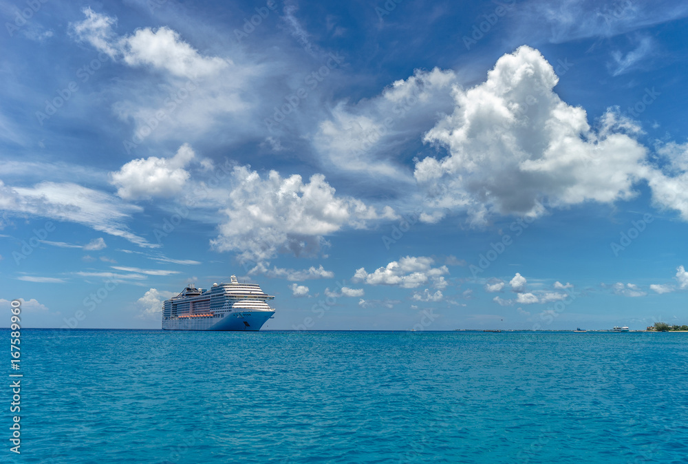 Cruise ship in crystal blue water and beautiful clouds