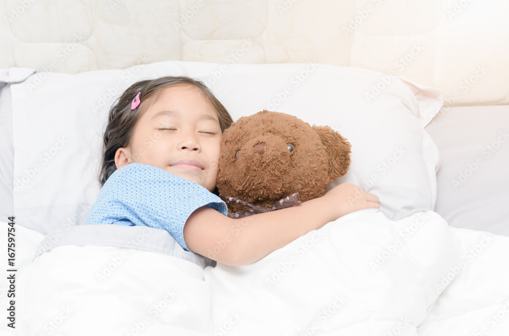 cute little asian girl sleep and hug teddy bear on bed cute little asian girl sleep and hug teddy bear on bed
