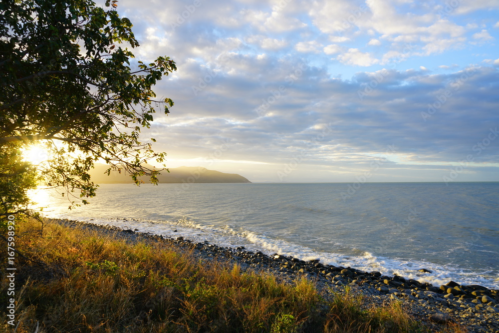 Sunset over the sea off the Captain Cook Highway between Cairns and Mossman in Far North Queensland, Australia