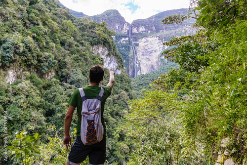 Young tourist pointing with finger on the Gocta waterfallGocta Watterfall/ Chachapoyas/ Peru/ south america photo