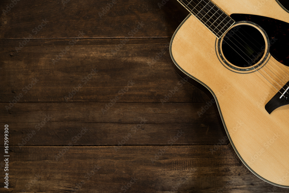 Fototapeta premium Acoustic guitar on wooden background