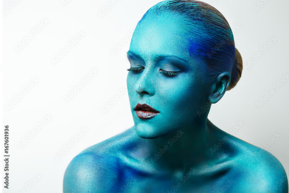 Girl with blue paint on her face. Creative make up, face art, body art.  Mystical image Stock Photo