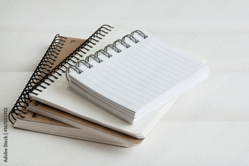 Notebooks on white wooden background Notebooks on white wooden background