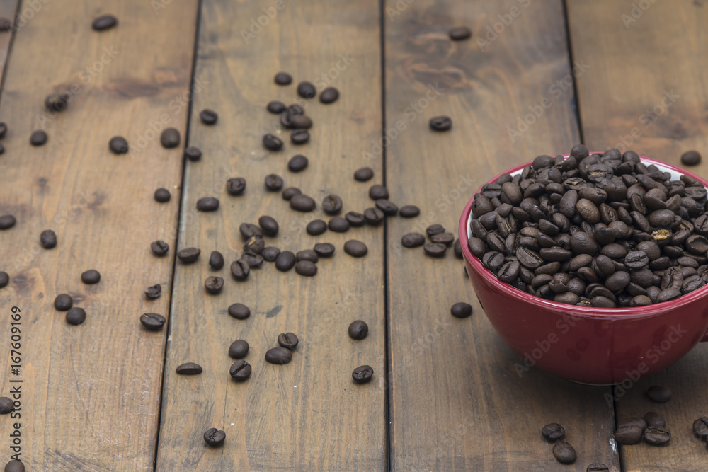 coffee beans in a coffee cup on a wooden floor coffee beans in a coffee cup on a wooden floor