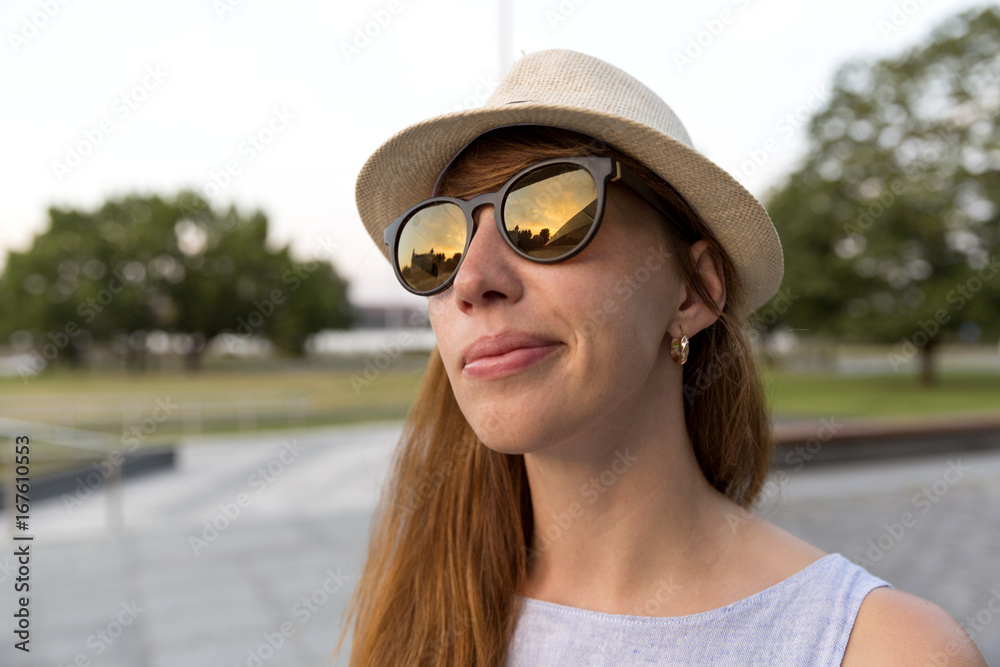 Young smiling woman in sunglasses outdoor