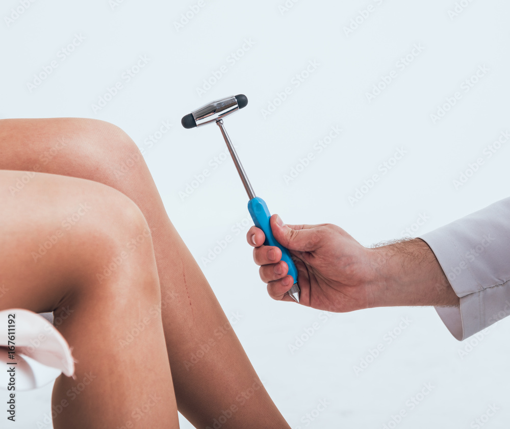 Orthopedic surgeon examining the knee reflex. The doctor checks the  physiological reflex. Test hammer Stock Photo | Adobe Stock