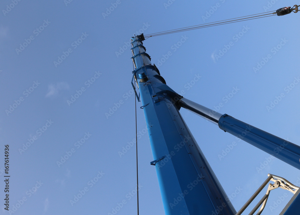 Immense hydraulic arm of a powerful crane for lifting heavy load Immense hydraulic arm of a powerful crane for lifting heavy load