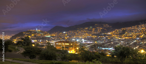 Panoramic view of downtown Quito, the Panecillo hill and the Ecuadorian Andes, moments after sunset. Quito, Pichincha, Ecuador.