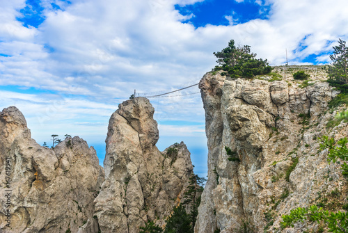 Rocks and a suspension bridge between them on top of the Ai-Petri mountain in the Crimea