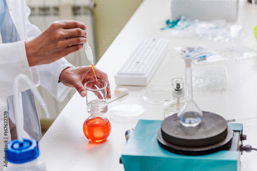 Hands of chemist doing lab experiment or test Hands of chemist doing lab experiment or test