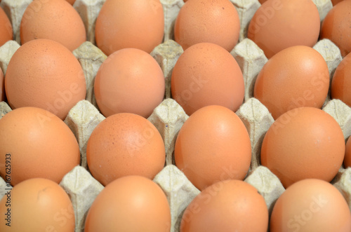 
Brown chicken eggs lie in the tray.