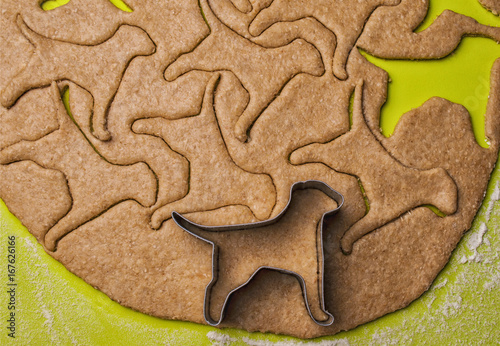 Making homemade dog treats in the shape of a bone.