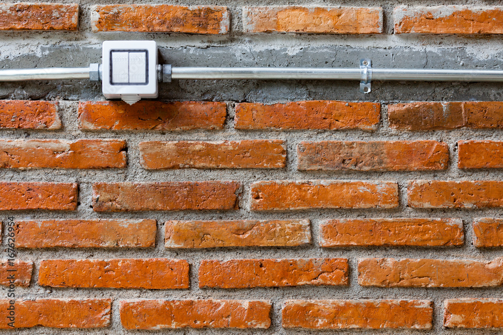 Traditional toggle white house electric light switch in Off position on empty brick wall Traditional toggle white house electric light switch in Off position on empty brick wall