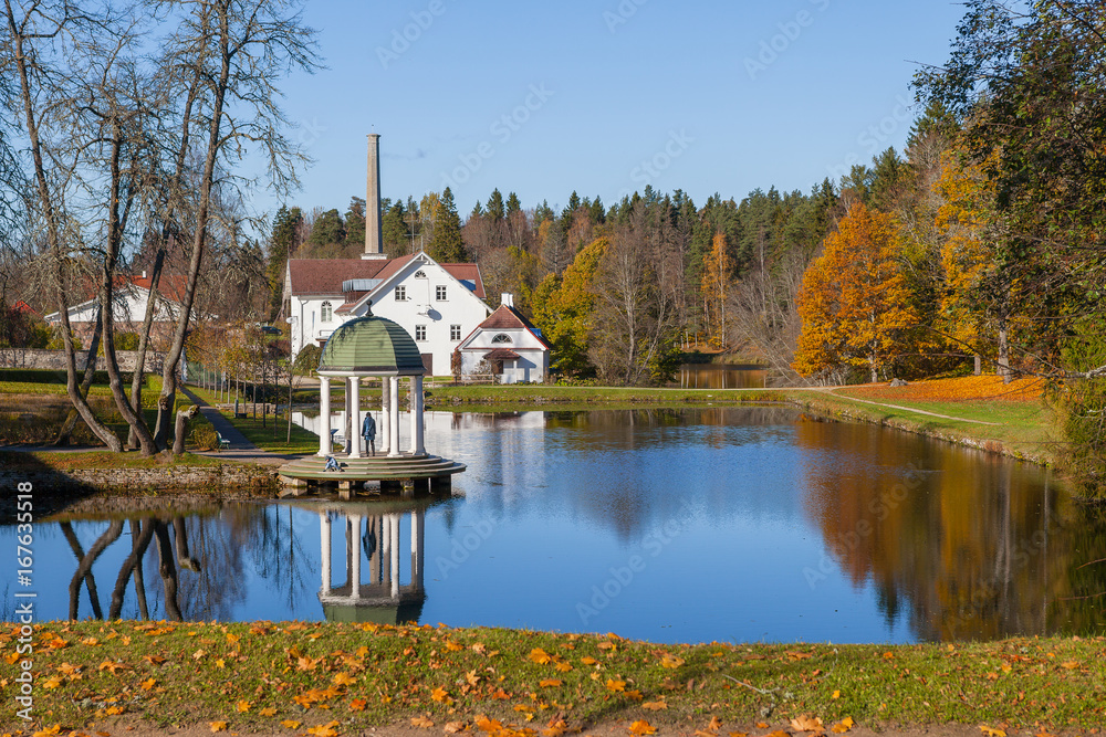 Rich old estate with a pond, rotunda and decorative pier. Palmse, Estonia. Autumn sunny day. Rich old estate with a pond, rotunda and decorative pier. Palmse, Estonia. Autumn sunny day.