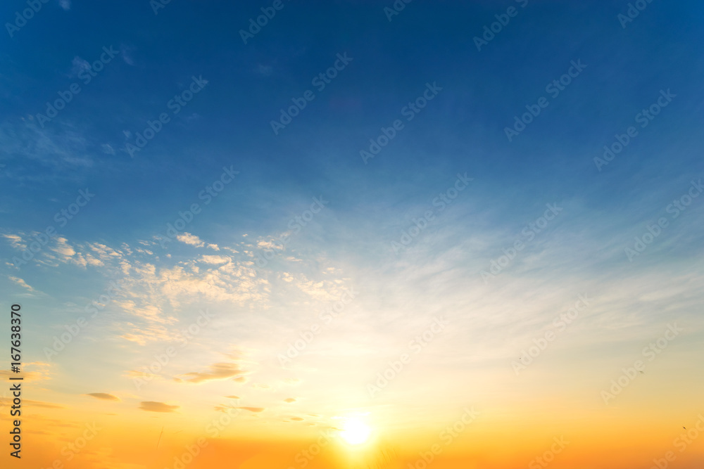 Sky background at sunset,Sky blue and orange light of the sun through the clouds in the sky