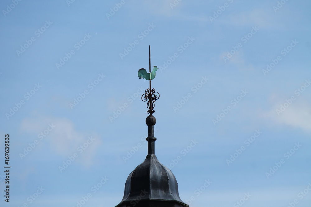 A Cockerel Wind Vane on Top of a Building Tower.