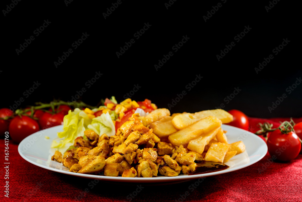 Fresh chicken with tomatoes and french fries Fresh chicken with tomatoes and french fries