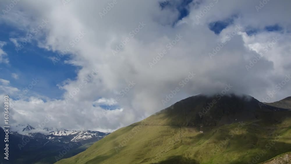clouds on the slopes of alpine mountains with peaks clouds on the slopes of alpine mountains with peaks