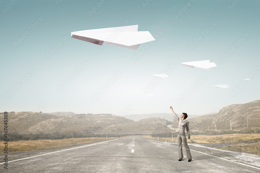 Obraz premium Origami plane flying in sky. Mixed media