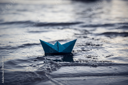 Blue lonely paper boat