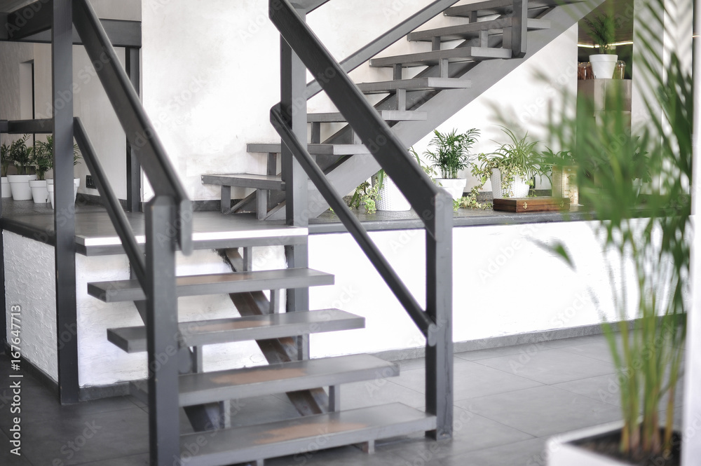 A stylish interior of a cozy cafe. Elements of interior. Original staircase
A stylish interior of a cozy cafe. Elements of interior. Original staircase