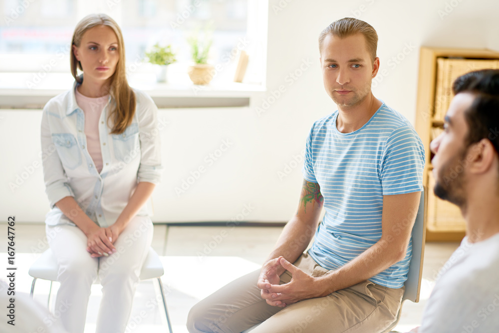 Obraz premium Young Man in Circle of Support Group