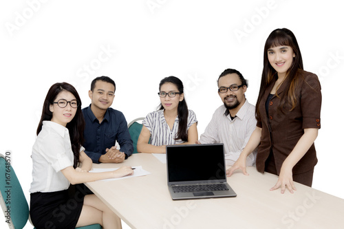 Multiracial workers with laptop on desk