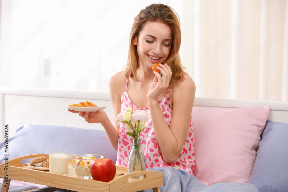 Young pretty woman having delicious breakfast in bed Young pretty woman having delicious breakfast in bed