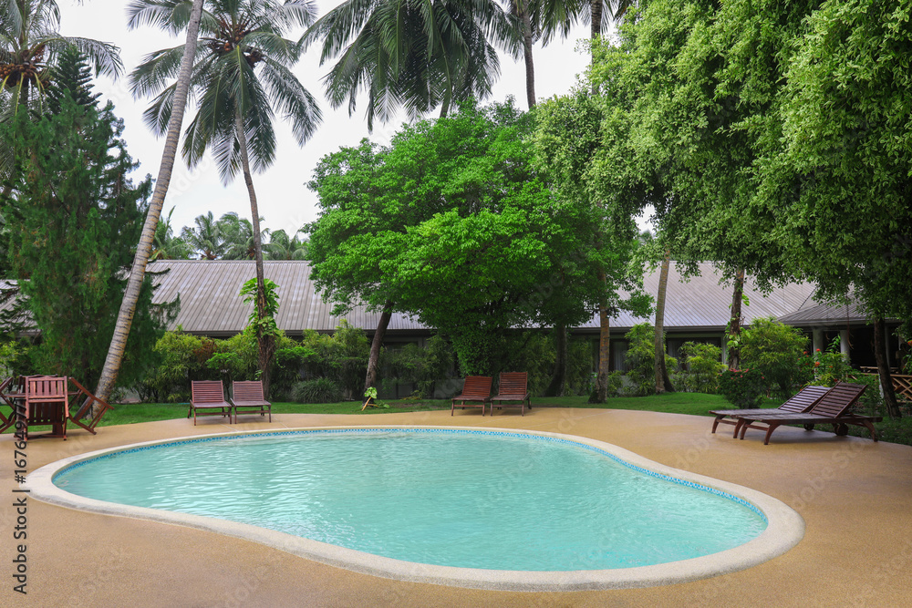 Bungalow with swimming pool at resort in summer day