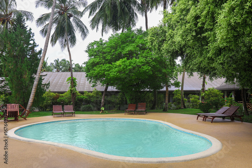 Bungalow with swimming pool at resort in summer day