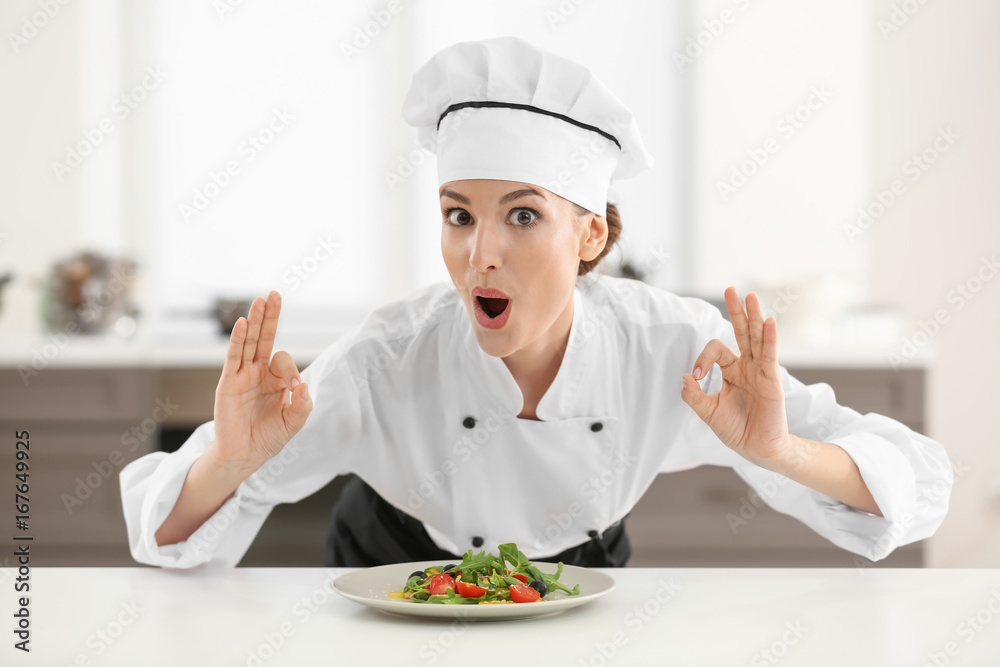 Young female chef in kitchen Young female chef in kitchen