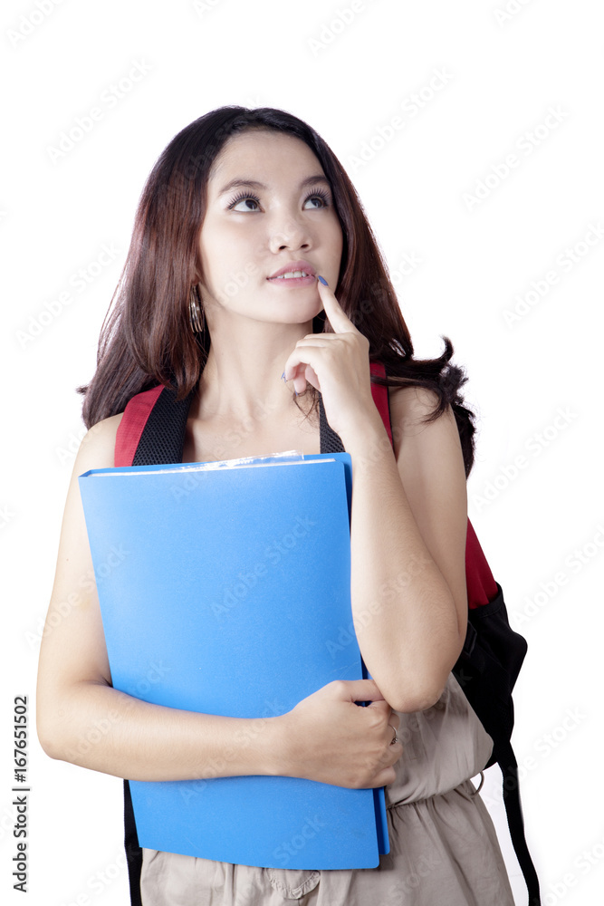 Thoughtful pretty student standing in studio Thoughtful pretty student standing in studio