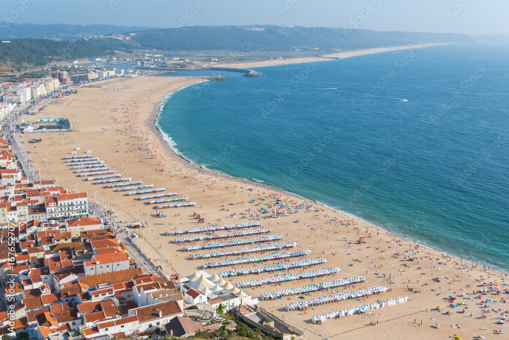     Nazare in Portugal in summer, beach and tiles roofs, people in holidays 
