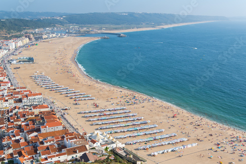  Nazare in Portugal in summer, beach and tiles roofs, people in holidays 