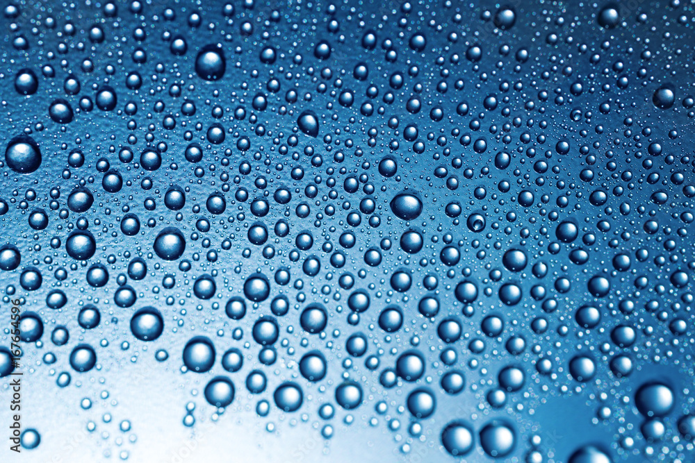 Water drops on rough surface, blue background Water drops on rough surface, blue background
