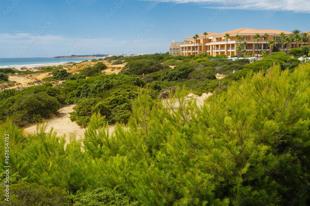 Sand dunes between hotels and beach of La Barrosa in Sancti Petri, Cadiz, Spain