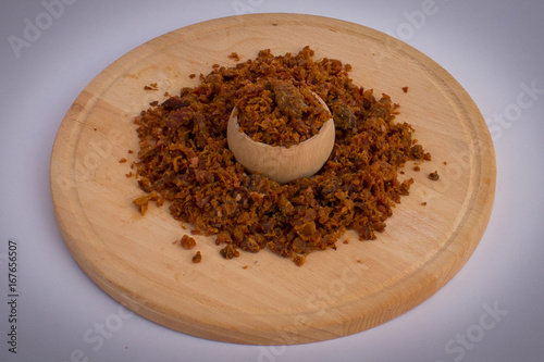 Homemade pork greaves in wooden bowl and on wooden plate photo