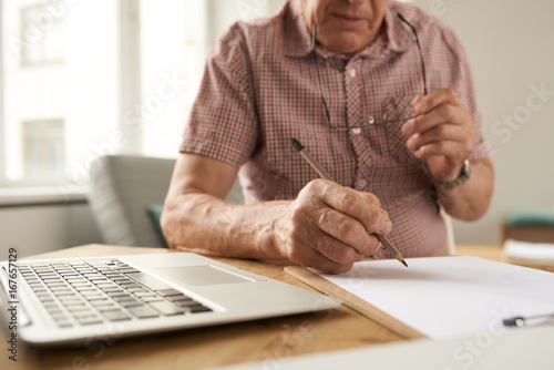 Senior Man Filling Forms at Home