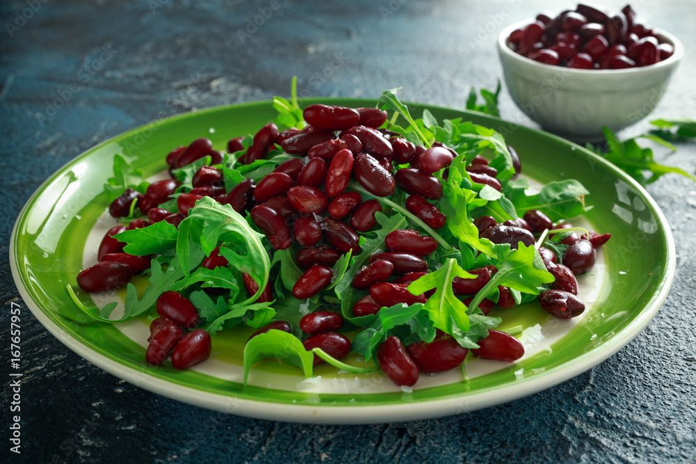 Red beans and wild rocket healthy salad in a green plate Red beans and wild rocket healthy salad in a green plate